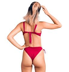 Sticker - Young beautiful woman wearing bikini backwards thinking about doubt with hand on head