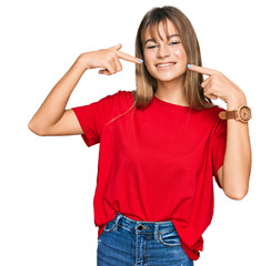 Wall Mural - Teenager caucasian girl wearing casual red t shirt smiling cheerful showing and pointing with fingers teeth and mouth. dental health concept.