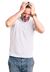 Sticker - Middle age handsome man wearing casual t-shirt suffering from headache desperate and stressed because pain and migraine. hands on head.