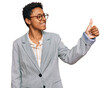 Young african american woman wearing business clothes looking proud, smiling doing thumbs up gesture to the side