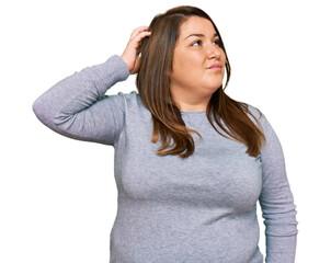 Wall Mural - Beautiful brunette plus size woman wearing casual clothes confuse and wondering about question. uncertain with doubt, thinking with hand on head. pensive concept.