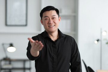 Wall Mural - Portrait of smiling friendly businessman in office