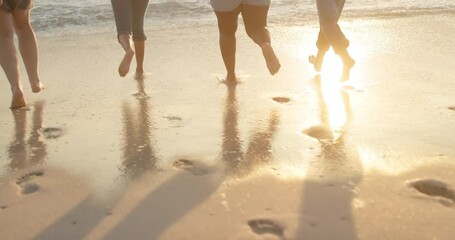 Canvas Print - Feet, legs and running into ocean at beach, friends vacation on tropical island with travel for fun and energy. Footprint, journey and adventure outdoor, people and sunshine with tourism and summer