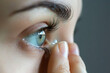 How to insert contact lenses. Woman apply lens to eye close up