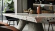 The dining room table features a terrazzo top adding a pop of color and character to the otherwise simple and modern design. The mix of concrete and terrazzo creates a unique and timeless .