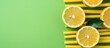 Several lemon slices arranged closely together on a vibrant green background, showcasing freshness and citrus appeal.