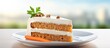 © Ilgun - Plate with a slice of delicious carrot cake next to a fresh carrot for a tasty treat