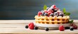 Waffle with vibrant berries and green mint leaves beautifully presented on a plate