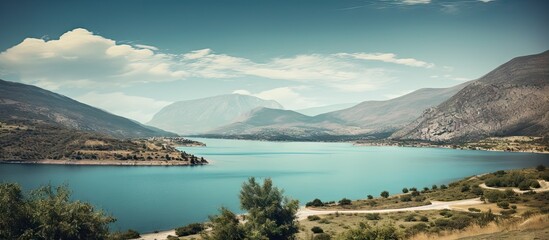 Canvas Print - The tranquil lake reflects the towering mountains in a picturesque setting of natural beauty