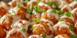A plate of tater tots covered in a creamy sauce. The tater tots are arranged in a way that they are all covered in the sauce, creating a delicious and appetizing dish