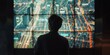 © kiimoshi - A man is looking at a large screen that shows a city. The man is wearing glasses and is standing in front of the screen