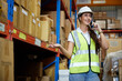 © offsuperphoto - factory worker talking on smartphone to customer in the warehouse factory