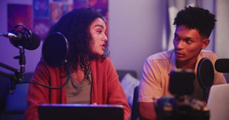 Poster - Podcast, man and woman in interview with mic, conversation and hosting online radio talk show in home. Live stream, broadcast and happy people vlogging with microphone chat, tech and content creation