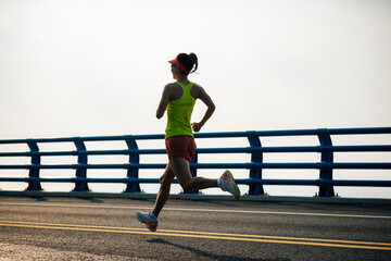 Sticker - Fitness woman runner running on seaside bridge