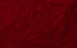 Clean dark red paper, wrinkled, abstract background.