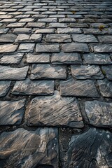 Poster - A picturesque cobblestone street with a clock tower in the background. Suitable for travel and historical concepts