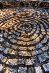 Poster - Circular stone structure in a park, suitable for landscaping projects