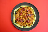 Fototapeta  - Spicy Mexican style rice with sliced avocado and sun dried tomatoes in a plate.