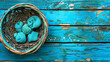 A basket of blue and white balls sits on a wooden table. The scene is simple and peaceful, with the blue and white balls creating a calming effect