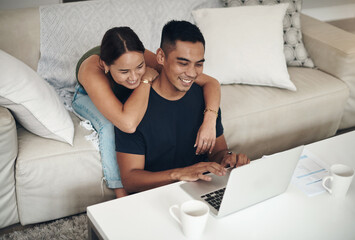 Laptop, smile and Asian couple in home for budget, savings or insurance at table in living room. Computer, man and woman on sofa for mortgage, financial planning and asset management on email online