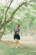 © Wicitr - Asian woman stretching and warming up before going for a run at the park. Yoga, health care, weight loss exercise.