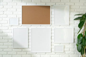 Poster - Varied Sized Photo Frames Displayed on a White Brick Wall