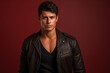 © MediaRaw - A man in a leather jacket is standing in front of a red background