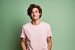 © MediaRaw - A young man in a pink shirt is smiling and looking at the camera