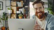 Proficient Caucasian consultant receiving online conference call using technologies. Cheerful bearded adult looking at webcam of portable computer while greeting colleague in home office.