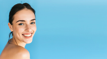 Wall Mural - Portrait of a beautiful, smiling woman on a blue background
