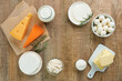 Dairy products or farm products. Fresh organic dairy products milk, cottage cheese, butter, cream, yogurt, sour cream and mozzarella on old wooden rustic background. Top view.