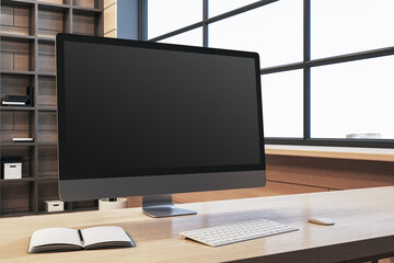 Poster - Close up of modern designer office workplace with empty computer monitor, window with city view and wooden shelves in the background. Mock up, 3D Rendering.