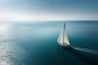 © Connect Images AI - A sailboat glides over a calm blue ocean under a clear sky, leaving a gentle wake trailing behind.