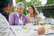 © peopleimages.com - Mature mother, female daughter and smile with lunch on table and conversation with father for eating and enjoyment. Family, happy and food with wine or meal and bonding together on holiday in nature