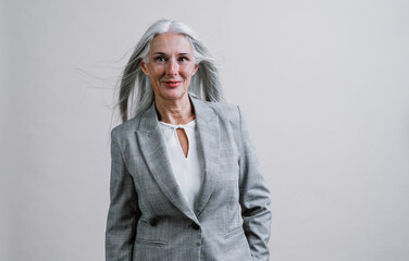 Beautiful senior woman posing on a corporate business  photo session.