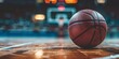Basketball on Glossy Hardwood Court Floor with Defocused Background