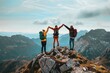 Triumphant trio raising hands on a mountain peak with scenic views