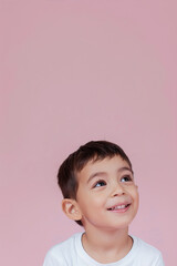 Little boy smiling on pink background
