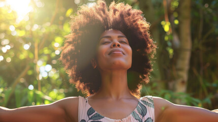 Portrait of a free happy black afro american woman with open arms enjoying life in meadows and nature background , young joyful african female with good mental health