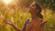 Portrait of a free happy Indian woman with open arms enjoying life in meadows and nature background , young joyful asian female with good mental health