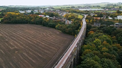 Wall Mural - Drone footage of Penistone Railway bridge near Barnsley, Showing a ploughed field and woodlands