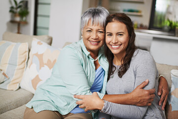 Wall Mural - Mother, smiles and hugs woman in home portrait for love, family or sharing moment together on sofa. People, happy and embrace in living room couch for bonding, connection and relationship growth