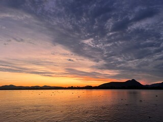 Sticker - Scenic view of a beautiful sunset over a lake