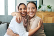 © peopleimages.com - Diversity, portrait and women hugging on sofa in living room of home together for bonding or visit. Love, relax and smile with happy young friends embracing in apartment for peace, support or trust