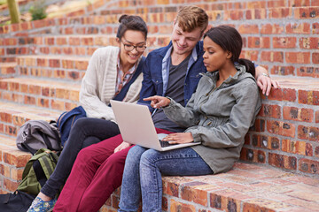 Wall Mural - Happy, group of students and laptop, sitting or bonding with laptop outside on campus stairs. College people, smile and computer with teamwork and support for study help with education at university