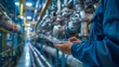 © Thanapipat - A manager using a digital tablet to review a safety compliance report in a factory