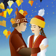 A girl and a guy in love in Kazakh national costumes against the background of a blue sky and falling autumn leaves.