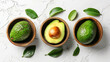 Fresh ripe avocados in bowls on a white textured background