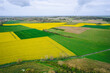 Photo aérienne par drone de champs en France incluant des champs de colza. 