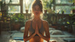 Young woman relaxes and meditates at home after yoga class.